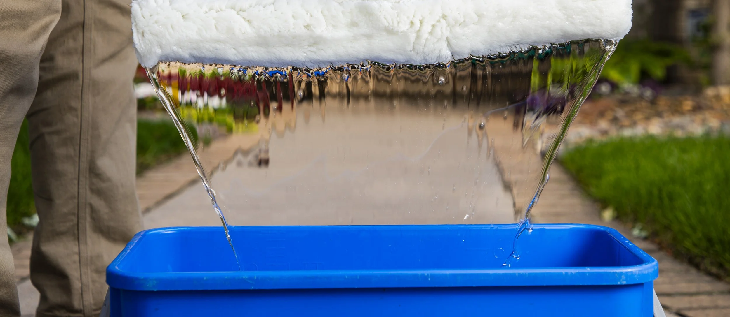 Purified water cascading from an Upscale Home Services bucket